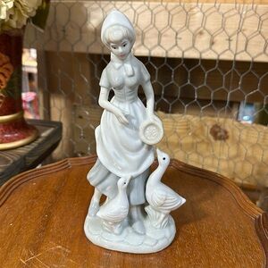 Lady with ducks figurine.